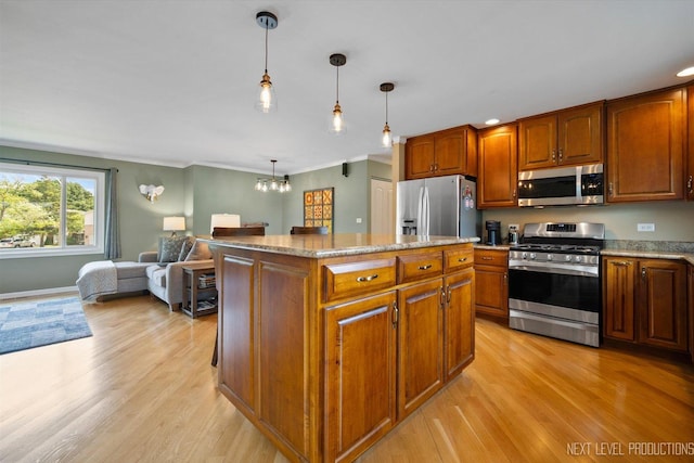 1035 Warwick Cir N, Hoffman Estates, IL 60169 - kitchen with stainless steel appliances, light wood-style floors, a chandelier, open floor plan, and pendant lighting