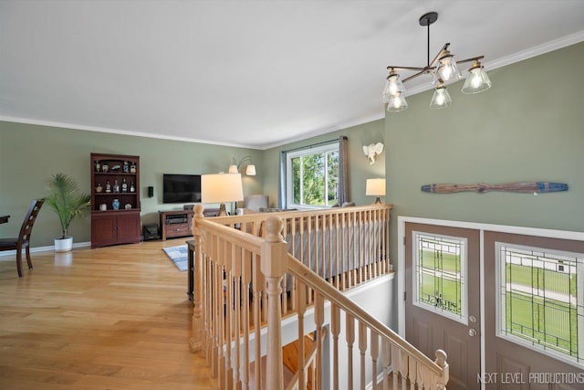 1035 Warwick Cir N, Hoffman Estates, IL 60169 - hallway featuring an upstairs landing, light wood-style floors, and ornamental molding