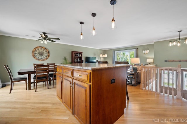 1035 Warwick Cir N, Hoffman Estates, IL 60169 - kitchen featuring ornamental molding, light wood finished floors, a center island, decorative light fixtures, and open floor plan