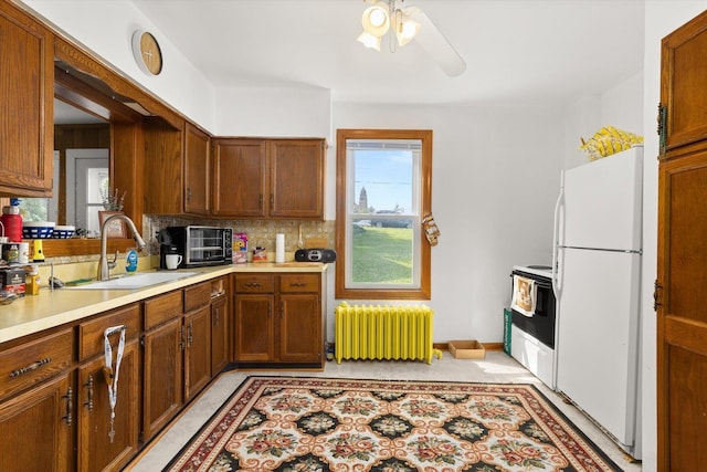 415 Fremont St, Lemont, IL 60439 - kitchen with radiator, freestanding refrigerator, a sink, light countertops, and range with electric stovetop