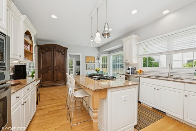 400 Saint Andrews Ln, Gurnee, IL 60031 - kitchen featuring a kitchen island, stainless steel appliances, white cabinetry, light wood-type flooring, and recessed lighting