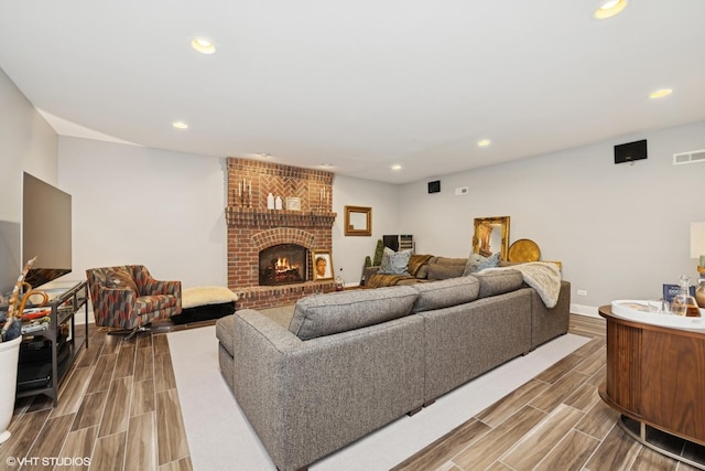 400 Saint Andrews Ln, Gurnee, IL 60031 - living area with wood tiled floors, recessed lighting, and a brick fireplace