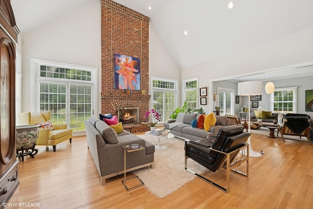 400 Saint Andrews Ln, Gurnee, IL 60031 - living room with high vaulted ceiling, light wood finished floors, a brick fireplace, and recessed lighting