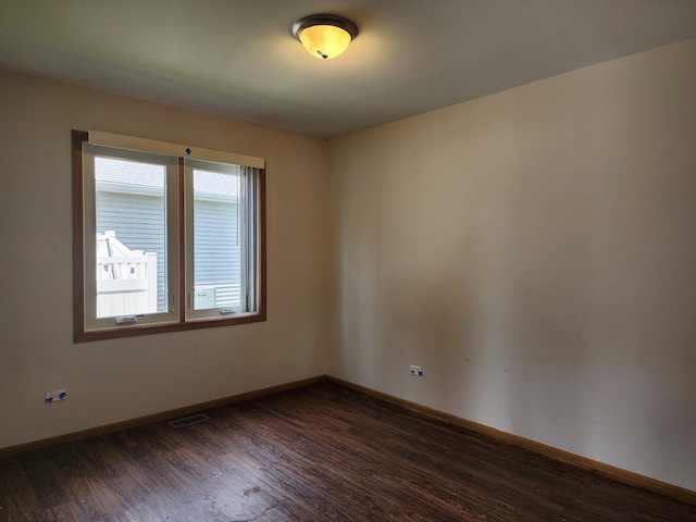 609 Flanagan Dr, Minooka, IL 60447 - empty room featuring dark wood finished floors and baseboards