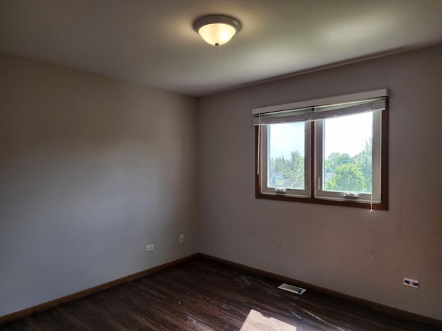 609 Flanagan Dr, Minooka, IL 60447 - unfurnished room featuring dark wood-type flooring and baseboards