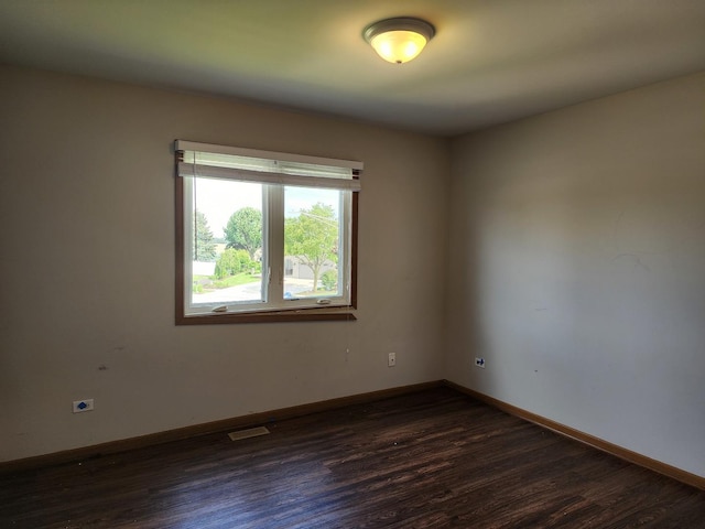 609 Flanagan Dr, Minooka, IL 60447 - empty room featuring dark wood-type flooring and baseboards