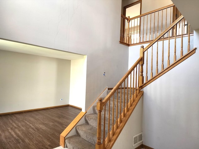 609 Flanagan Dr, Minooka, IL 60447 - staircase with wood finished floors and a towering ceiling
