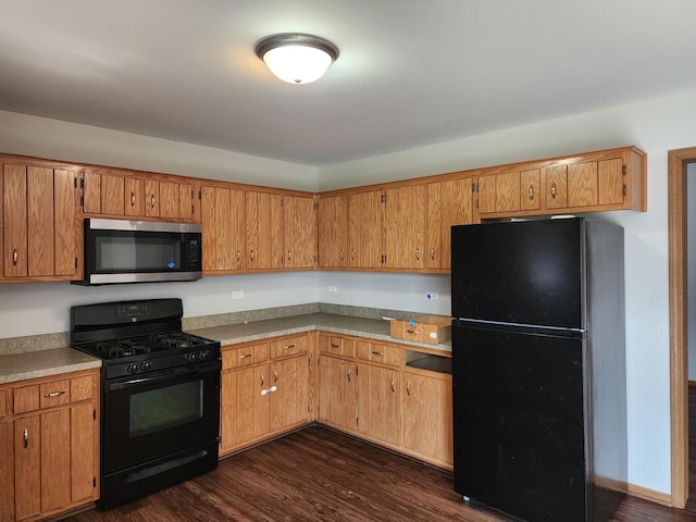 609 Flanagan Dr, Minooka, IL 60447 - kitchen with black appliances, dark wood-type flooring, brown cabinets, and light countertops