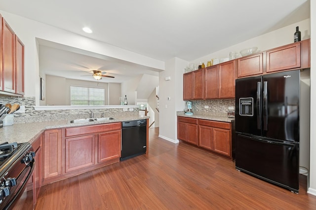 6518 Lilac Blvd, Hanover Park, IL 60133 - kitchen with black appliances, dark wood-type flooring, backsplash, ceiling fan, and a peninsula