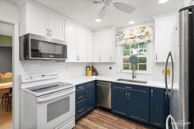 23551 W Winston Ave, Plainfield, IL 60586 - kitchen with appliances with stainless steel finishes, blue cabinets, a ceiling fan, white cabinets, and light countertops