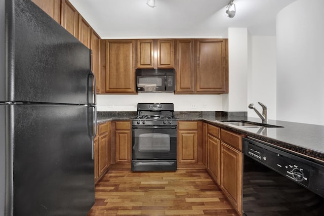 1255 S State St Unit 1704, Chicago, IL 60605 - kitchen featuring black appliances, light wood finished floors, and brown cabinetry