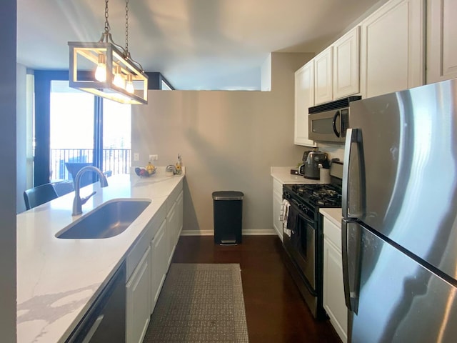 210 S Desplaines St Unit 1410, Chicago, IL 60661 - kitchen with appliances with stainless steel finishes, white cabinetry, decorative light fixtures, light stone counters, and dark wood-style flooring