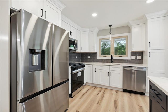 919 E Cooper Dr, Palatine, IL 60074 - kitchen with appliances with stainless steel finishes, white cabinets, tasteful backsplash, light wood finished floors, and hanging light fixtures