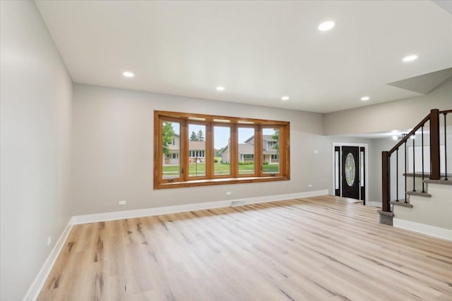 919 E Cooper Dr, Palatine, IL 60074 - unfurnished living room with light wood finished floors, recessed lighting, and stairway