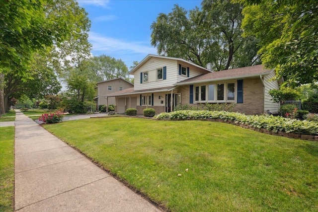 919 E Cooper Dr, Palatine, IL 60074 - view of front facade with brick siding, driveway, a front lawn, and an attached garage