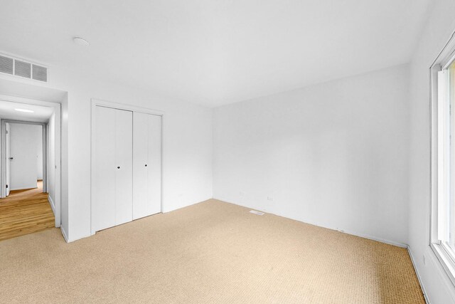 137 S Schmidt Rd, Bolingbrook, IL 60440 - unfurnished bedroom featuring light colored carpet and a closet