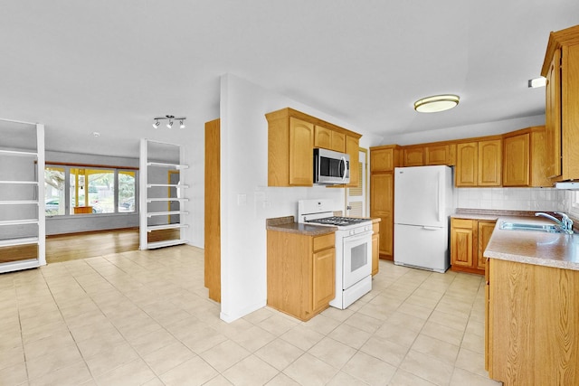 137 S Schmidt Rd, Bolingbrook, IL 60440 - kitchen featuring white appliances, a sink, light tile patterned floors, and brown cabinetry