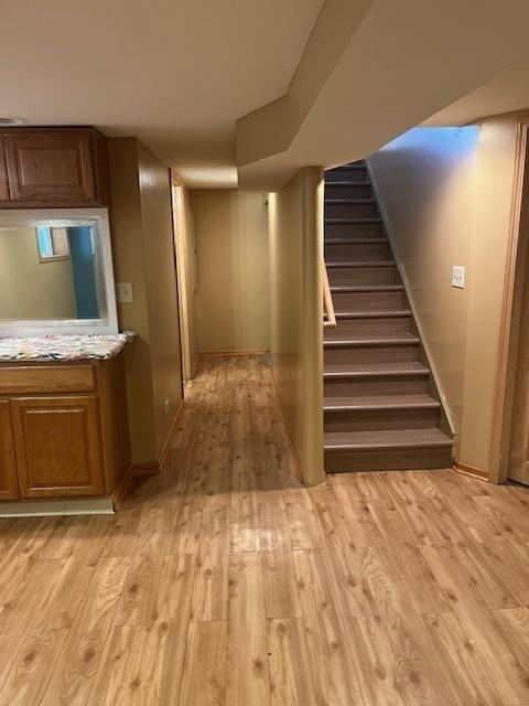 6111 S Menard Ave, Chicago, IL 60638 - finished below grade area featuring light wood-type flooring, stairs, and baseboards