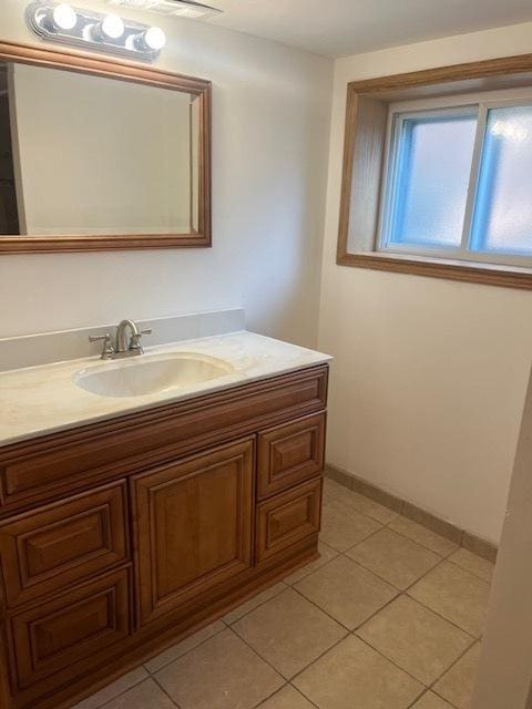 6111 S Menard Ave, Chicago, IL 60638 - bathroom featuring vanity, tile patterned floors, and baseboards