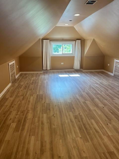 6111 S Menard Ave, Chicago, IL 60638 - additional living space featuring wood finished floors, baseboards, and lofted ceiling