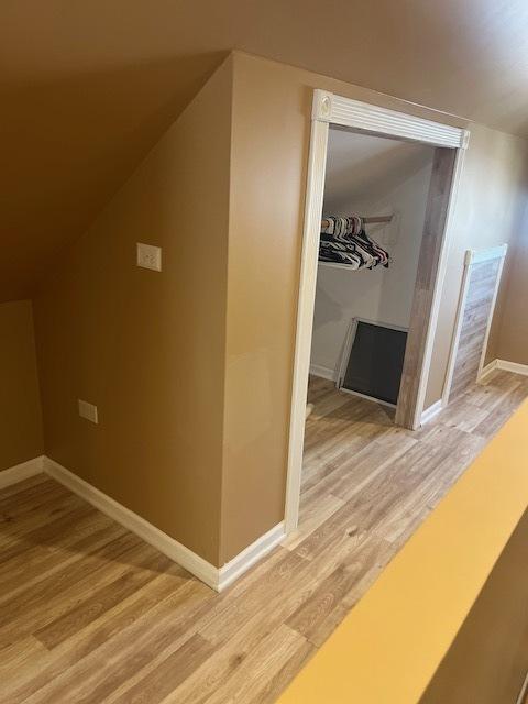 6111 S Menard Ave, Chicago, IL 60638 - additional living space with light wood-type flooring, baseboards, and lofted ceiling