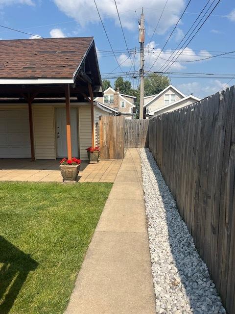 6111 S Menard Ave, Chicago, IL 60638 - view of side of home featuring a shingled roof and a garage