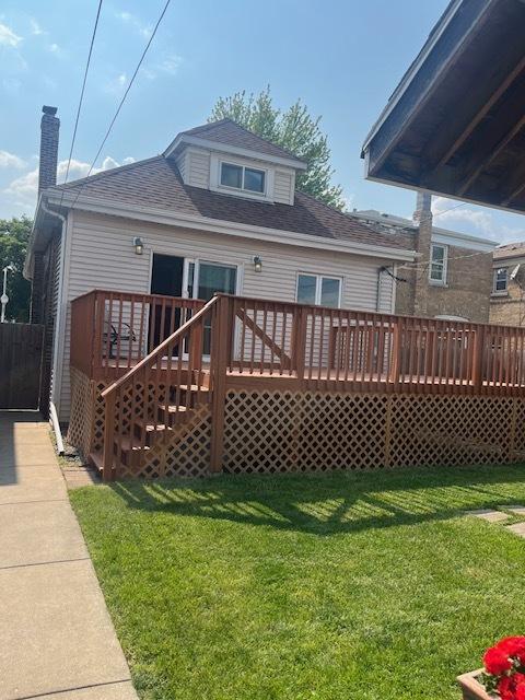 6111 S Menard Ave, Chicago, IL 60638 - rear view of house featuring a wooden deck, a shingled roof, and a lawn