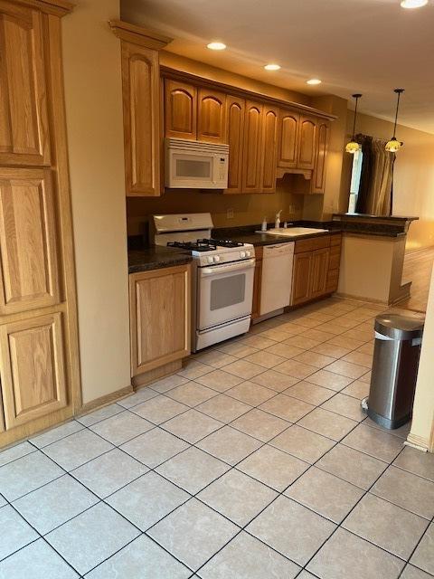 6111 S Menard Ave, Chicago, IL 60638 - kitchen featuring white appliances, a sink, light tile patterned floors, dark countertops, and pendant lighting