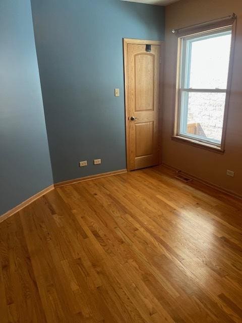 6111 S Menard Ave, Chicago, IL 60638 - empty room featuring wood finished floors and baseboards