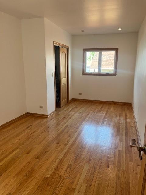 6111 S Menard Ave, Chicago, IL 60638 - empty room featuring wood finished floors and baseboards