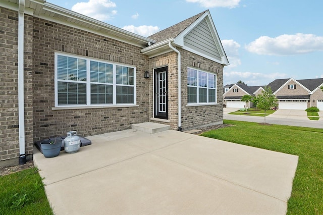 1518 128th St, Lemont, IL 60439 - property entrance with a patio, brick siding, and a lawn