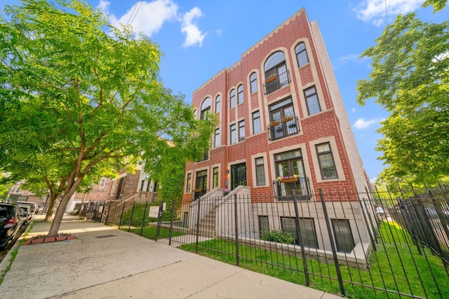 1704 S Carpenter St Unit 3B, Chicago, IL 60608 - view of building exterior with a fenced front yard