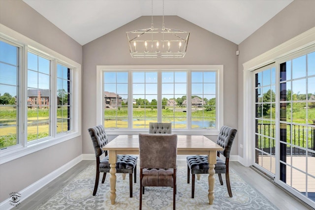 8830 Indiana Harbor Dr, Frankfort, IL 60423 - dining space with a chandelier, vaulted ceiling, light wood-style floors, and healthy amount of natural light