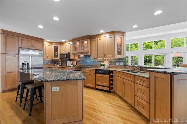 1614 Orth Dr, Wheaton, IL 60189 - kitchen with appliances with stainless steel finishes, healthy amount of natural light, a breakfast bar, recessed lighting, and light wood finished floors