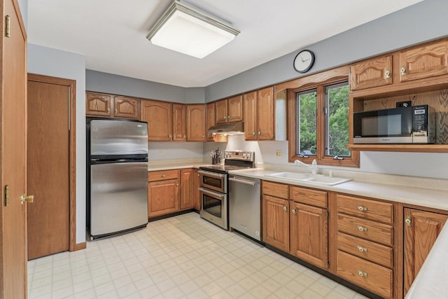 35932 N Watson Ave, Ingleside, IL 60041 - kitchen with stainless steel appliances, under cabinet range hood, brown cabinets, light countertops, and light flooring