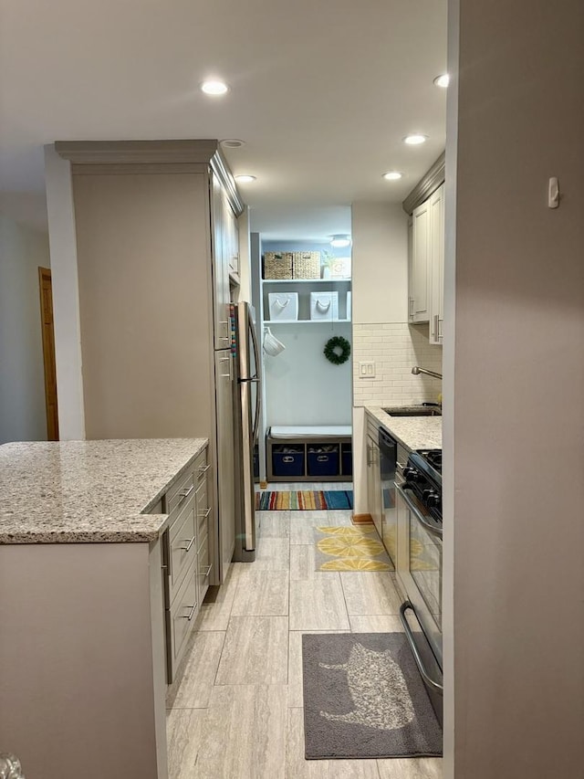 1227 S Old Wilke Rd Unit 104, Arlington Heights, IL 60005 - kitchen with light wood-style floors, backsplash, stainless steel dishwasher, recessed lighting, and light stone countertops