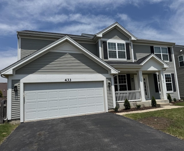 433 Minuet Cir, Volo, IL 60073 - traditional-style home with a porch, asphalt driveway, and a garage