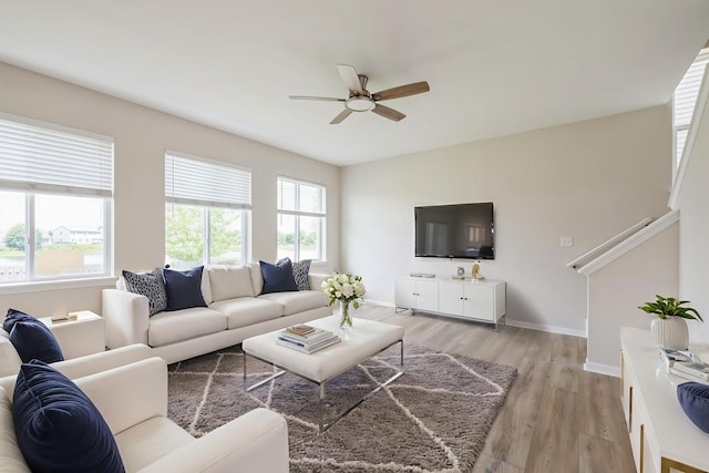 433 Minuet Cir, Volo, IL 60073 - living room featuring a ceiling fan, light wood-style flooring, and stairs