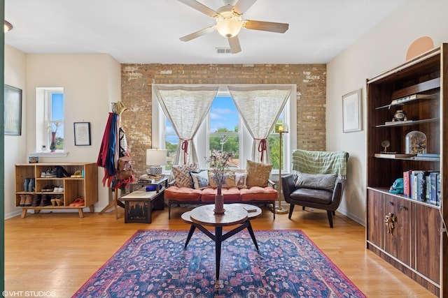 6100 N Rockwell St Unit 3S, Chicago, IL 60659 - living area with a ceiling fan, wood finished floors, and brick wall
