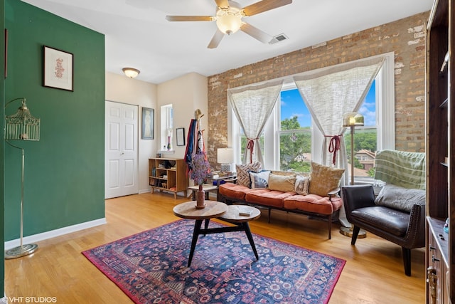 6100 N Rockwell St Unit 3S, Chicago, IL 60659 - living area featuring a ceiling fan, wood finished floors, brick wall, and baseboards