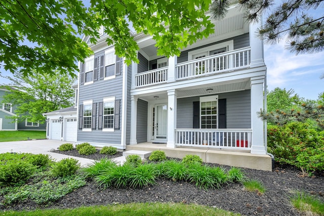 3095 Long Common Pkwy, Elgin, IL 60124 - view of front facade featuring a balcony, covered porch, concrete driveway, and an attached garage