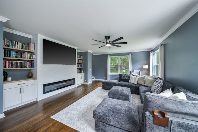 3095 Long Common Pkwy, Elgin, IL 60124 - living room with ornamental molding, dark wood-style flooring, a ceiling fan, a fireplace, and built in shelves