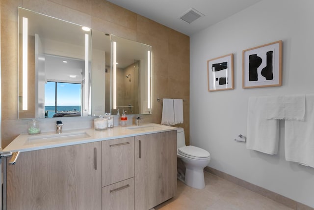 211 N Harbor Dr Unit 1902, Chicago, IL 60601 - ensuite bathroom featuring double vanity, toilet, tile walls, and baseboards
