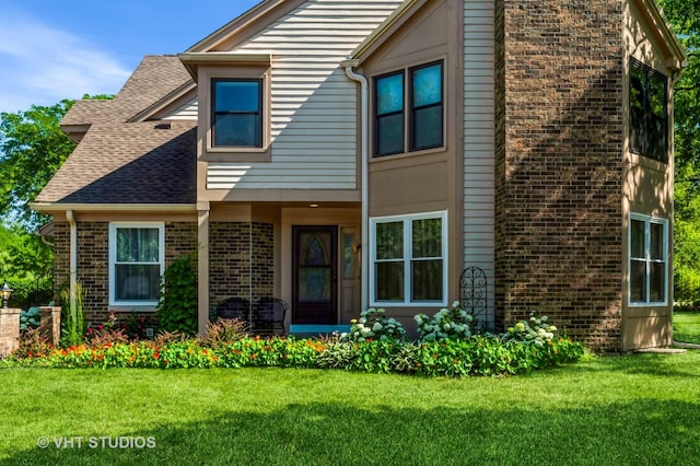 75 Willow Pkwy, Buffalo Grove, IL 60089 - view of front of home with a chimney, a front yard, brick siding, and a shingled roof