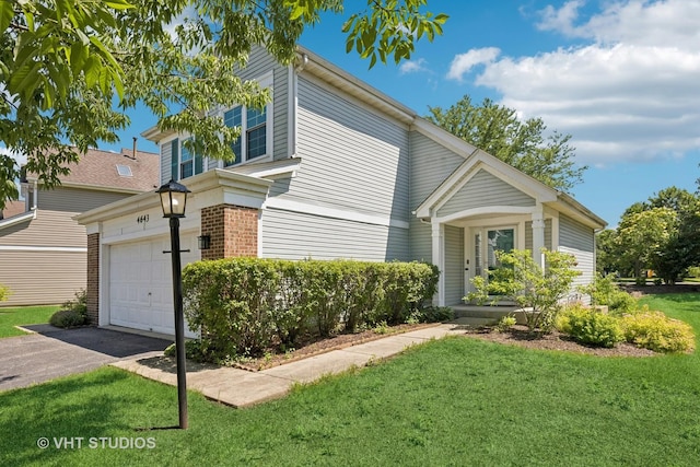 4643 Rolling Hills Dr, Lake In The Hills, IL 60156 - traditional home featuring a front yard, a garage, driveway, and brick siding
