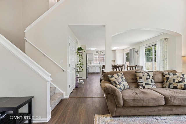 4643 Rolling Hills Dr, Lake In The Hills, IL 60156 - living area featuring arched walkways, dark wood-type flooring, stairway, and a high ceiling