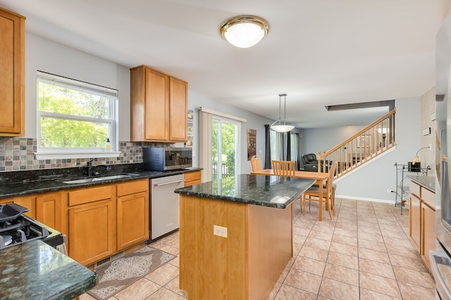 1216 Barlina Rd, Crystal Lake, IL 60014 - kitchen featuring appliances with stainless steel finishes, a center island, backsplash, dark stone counters, and hanging light fixtures