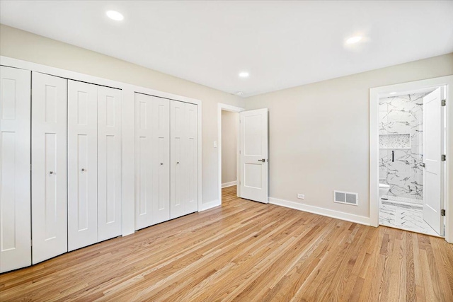 114 S Waverly Pl, Mount Prospect, IL 60056 - unfurnished bedroom with multiple closets, light wood-type flooring, connected bathroom, and recessed lighting