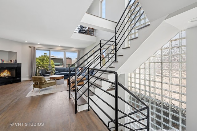 1645 W Erie St Unit 2, Chicago, IL 60622 - staircase featuring wood finished floors and a glass covered fireplace