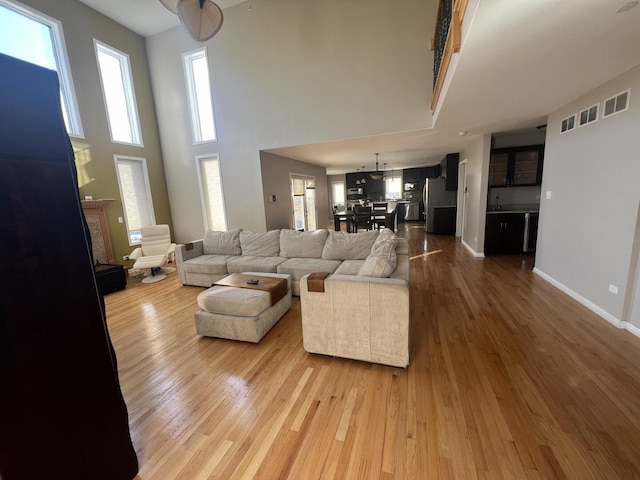 4429 203rd St, Matteson, IL 60443 - living area featuring wood finished floors, a high ceiling, a fireplace, and baseboards